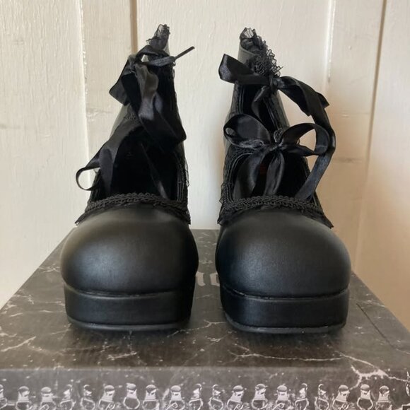 This is a pair of black platform high heels. - Picture 1 of 6